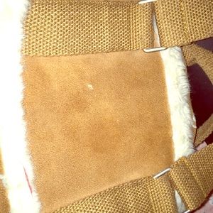 A brown fur purse with a streak of red